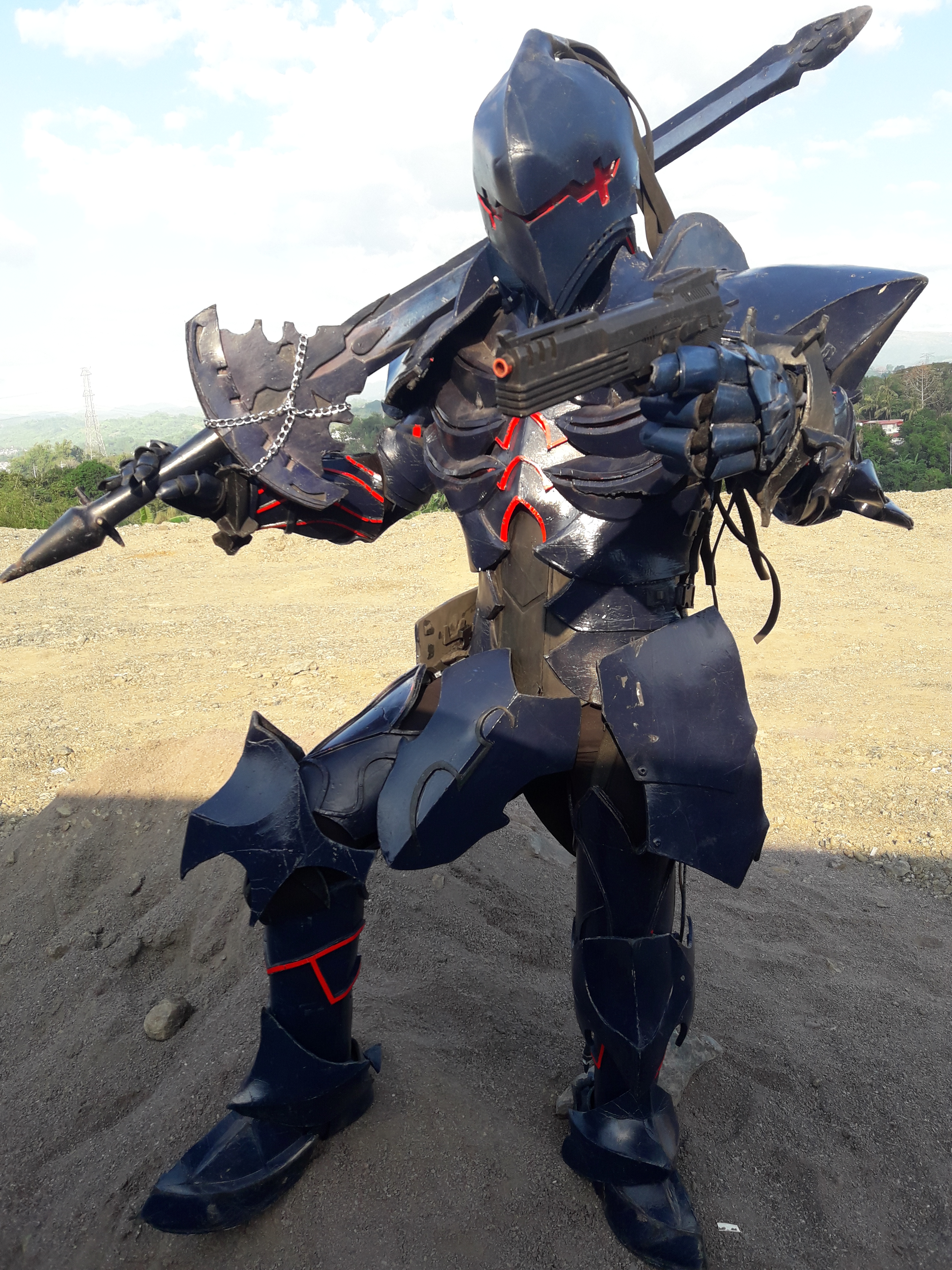 Man in black armor with sword and pistol