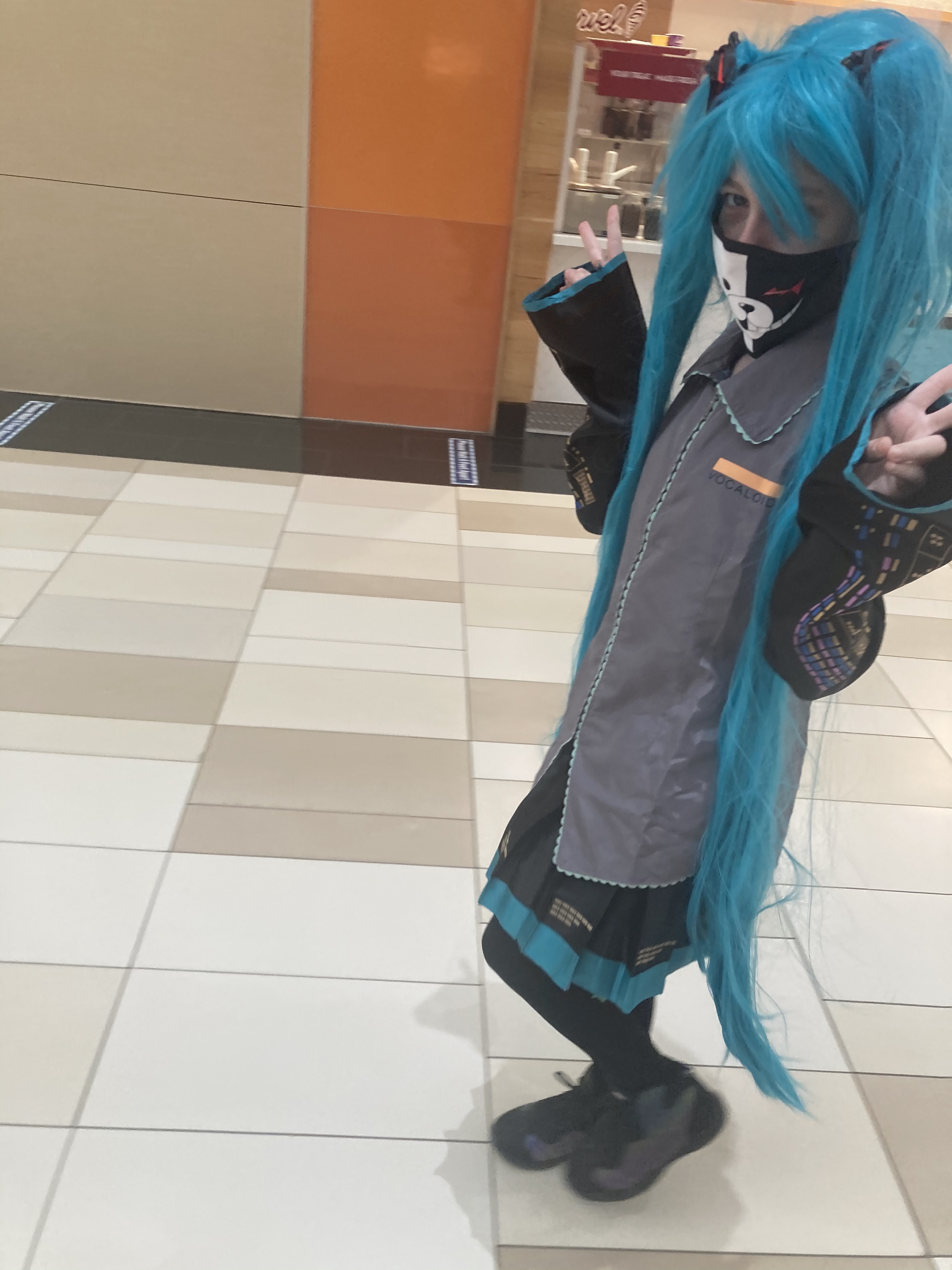 Smiling girl in blue-green wig