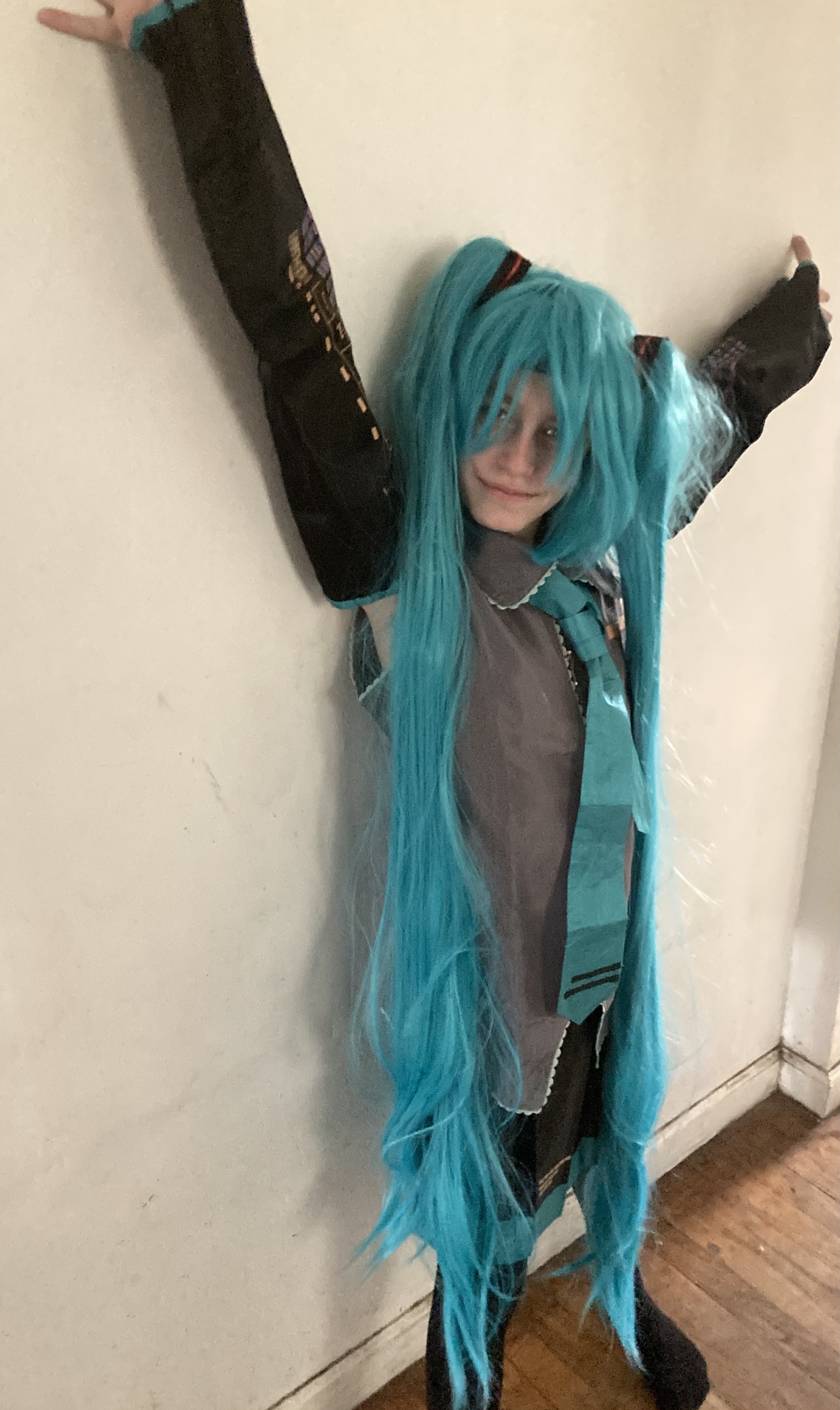 Smiling girl in blue-green wig