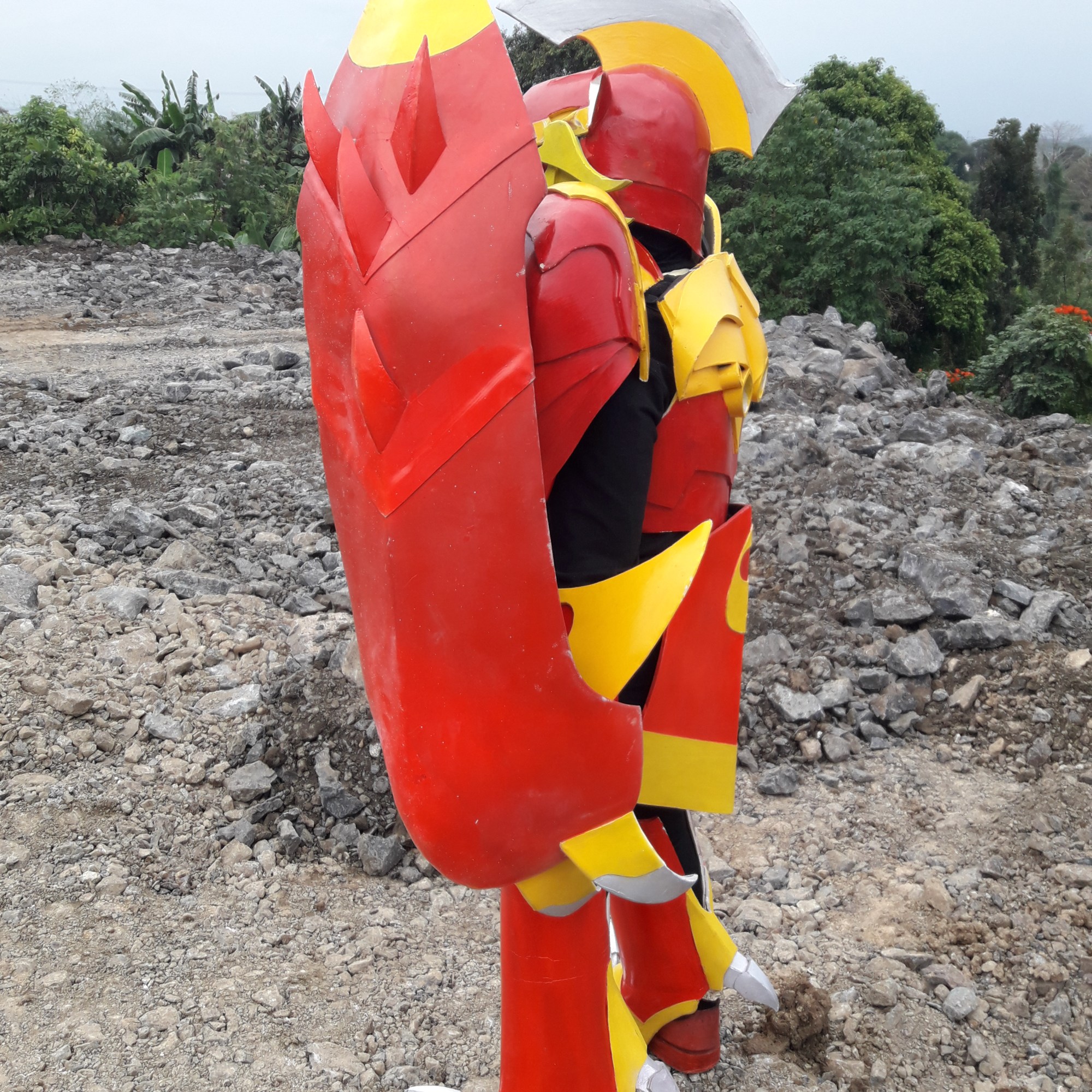 Cosplayer in armor painted in bright, warm colors