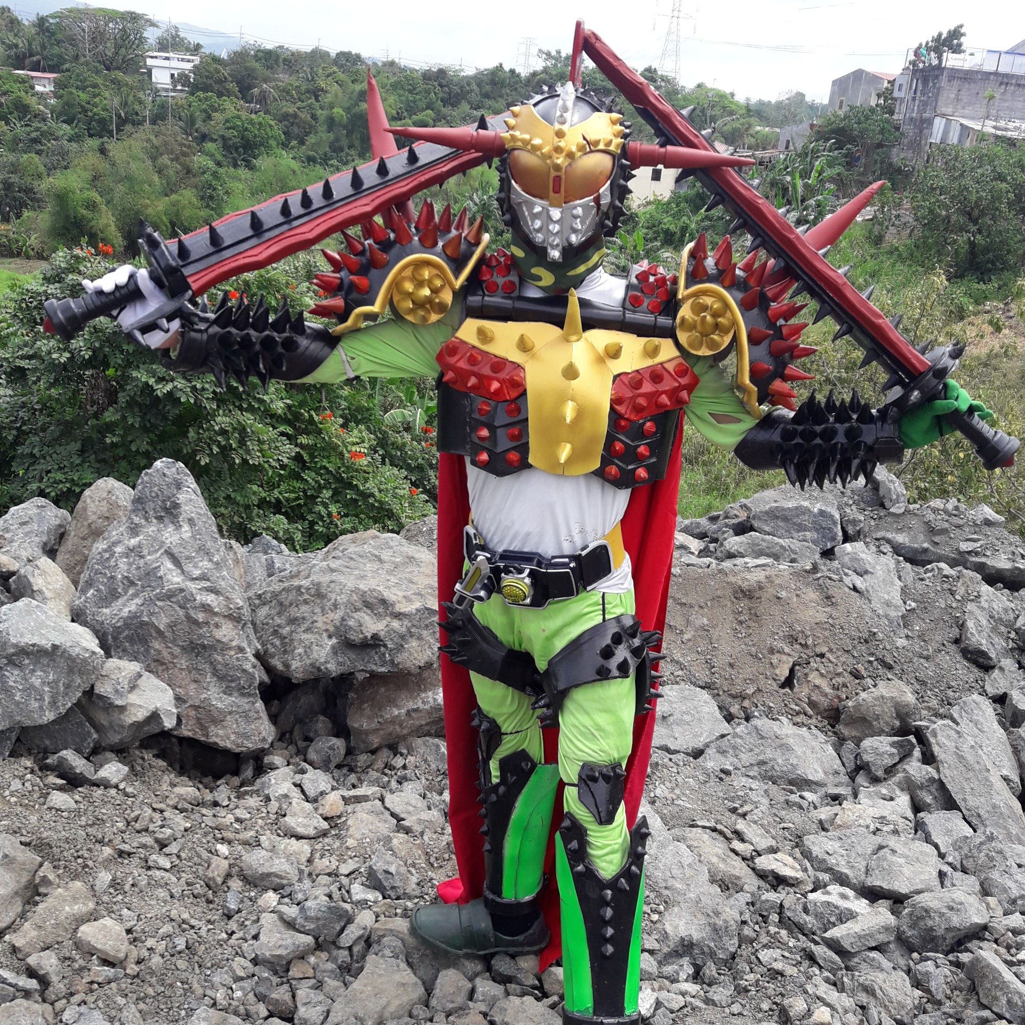 Cosplayer dressed in brightly colored bug-like costume with lots of spikes
