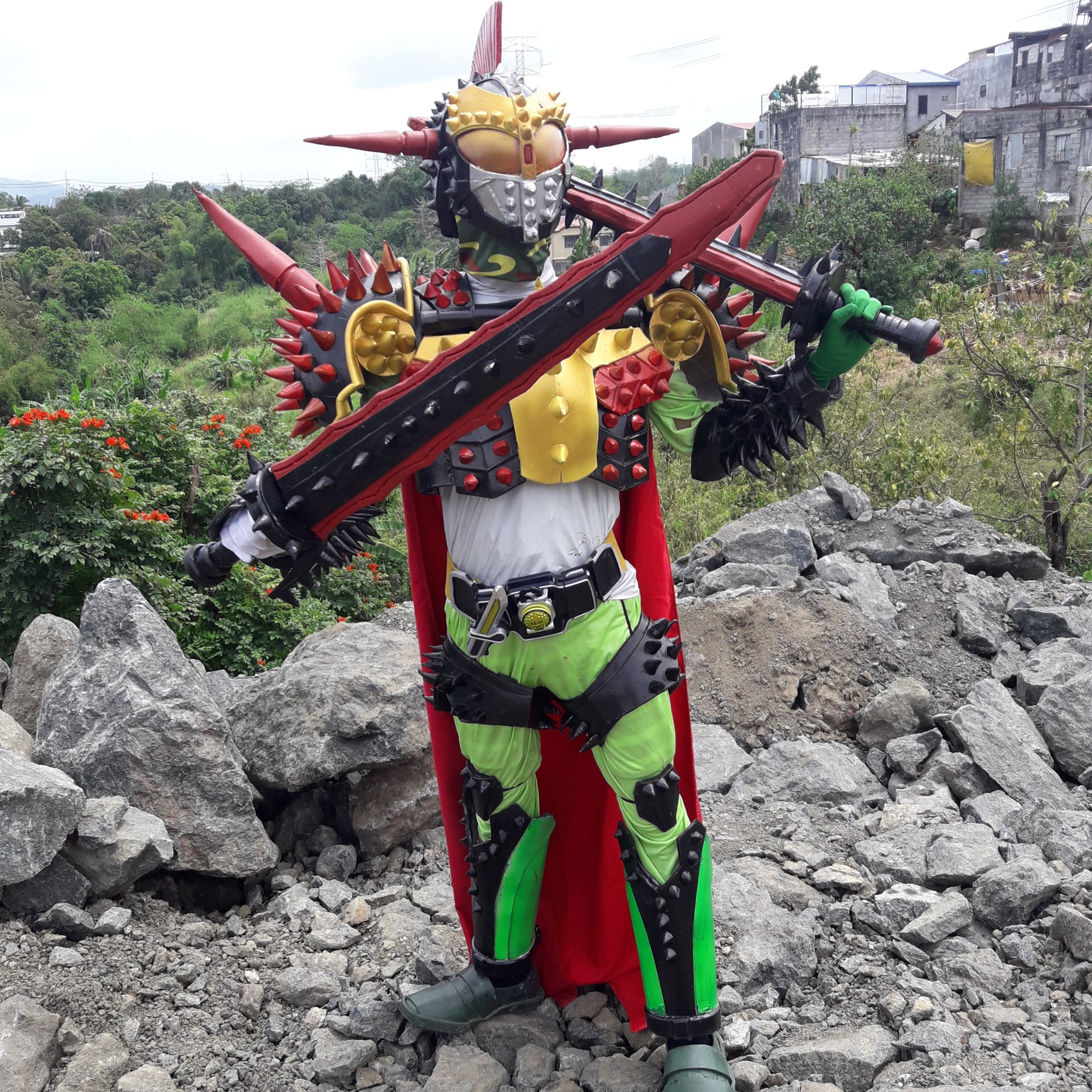 Cosplayer dressed in brightly colored bug-like costume with lots of spikes