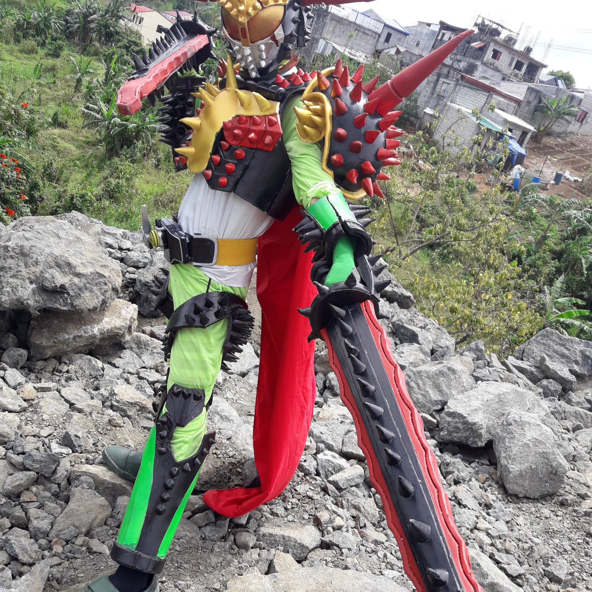 Cosplayer dressed in brightly colored bug-like costume with lots of spikes