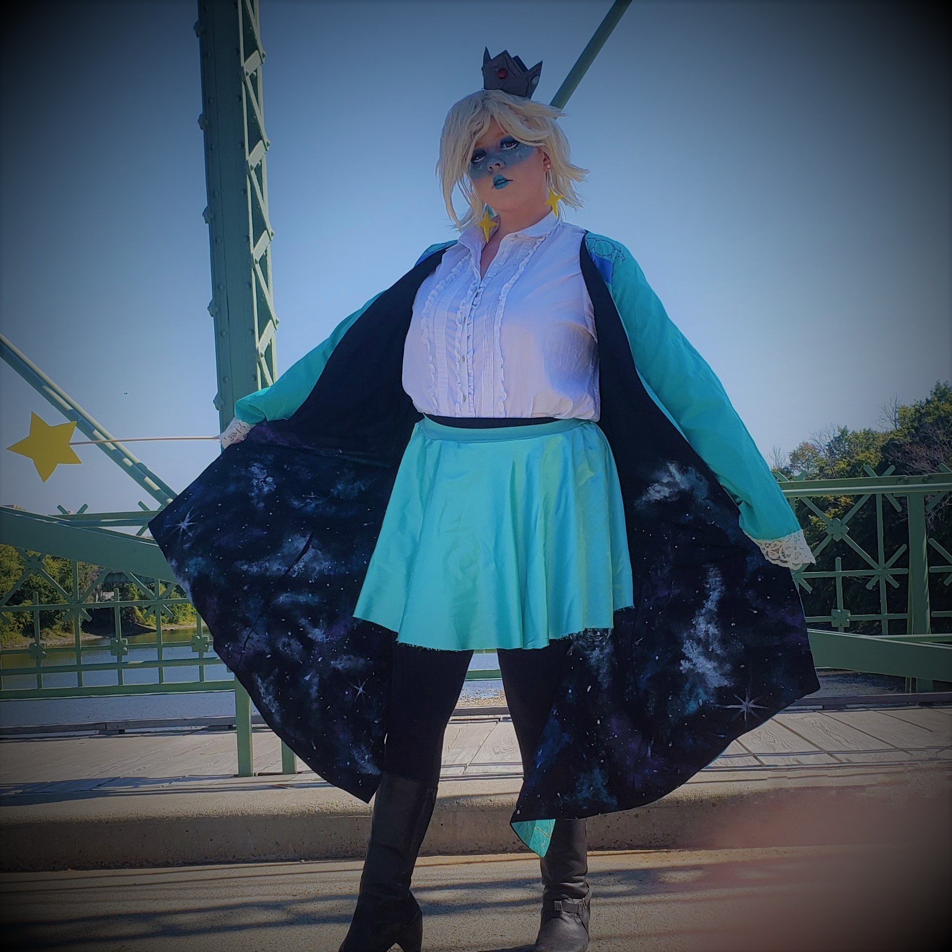 Cosplayer looking magical and spreading cloak wide