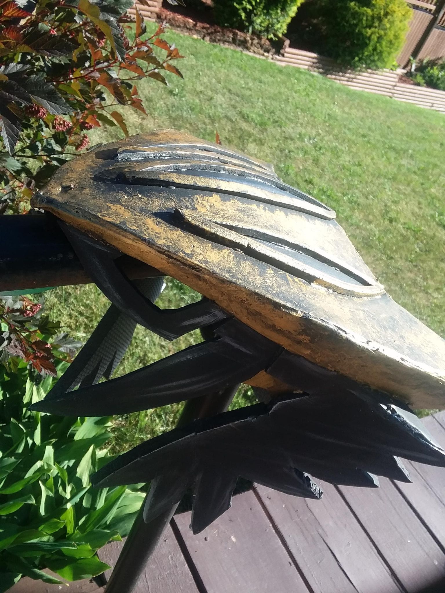 Armored version of hawkgirl. Gold and black hawk mask with a metallic finish, green leggings, red boots, big hawk wings that open and close, a mace, yellow top with arm bracers.