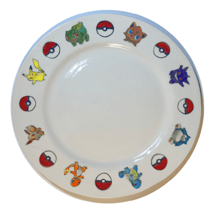 A porcelain plate with Pokemon symbols arrayed around the edges.