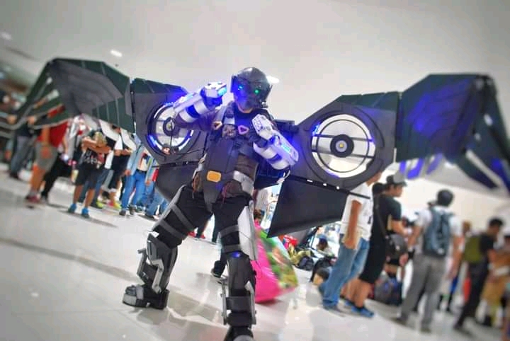 Mechanized suit with wings spread and circular fans built into the wings